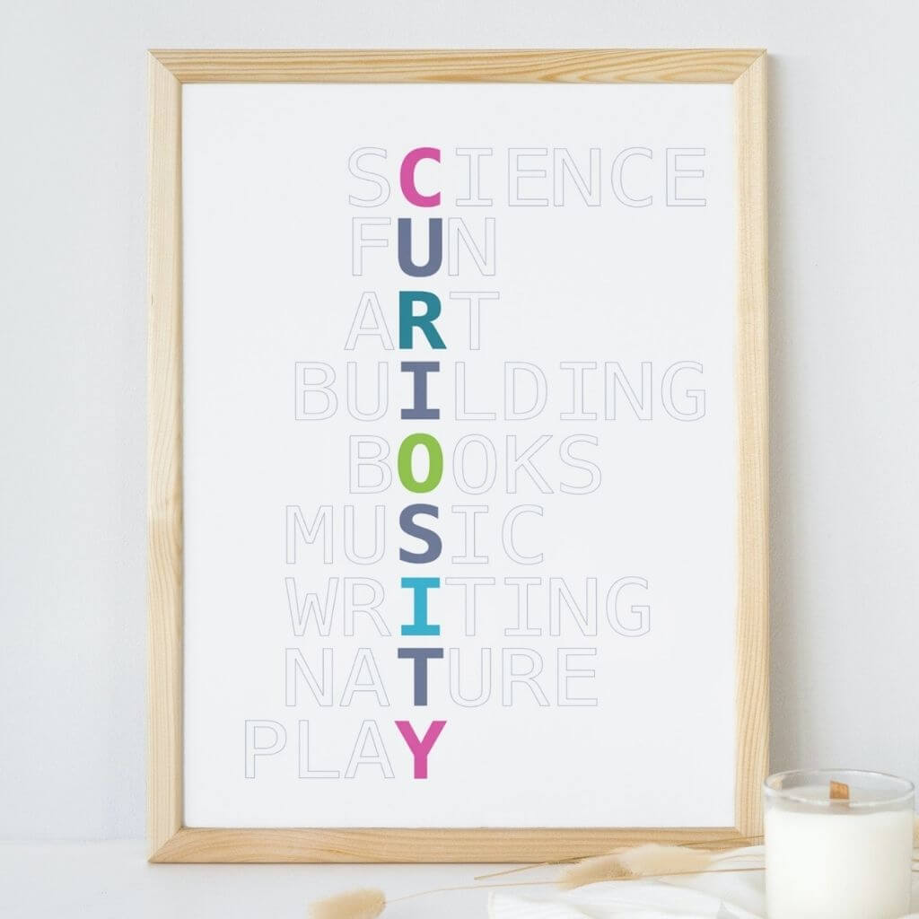 Playroom wall art with Curiosity written in jewel-toned colors vertically, with grayed out words intersecting horizontally. From top, they read Science, Fun, Art, Building, Books, Music, Writing, Nature, Play.